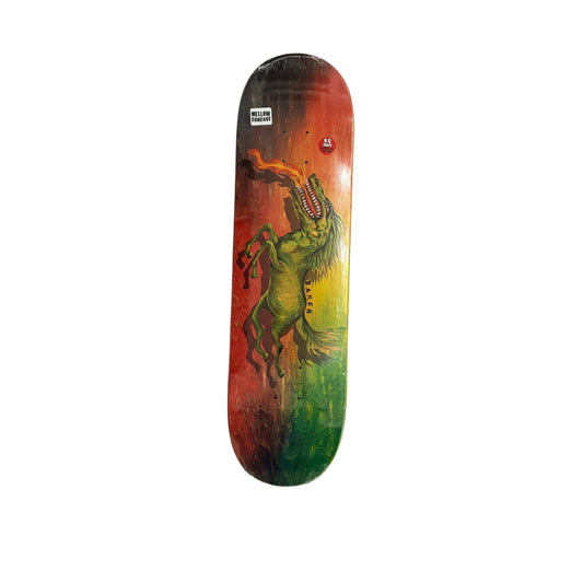 A skateboard deck featuring a graphic illustration of a green dinosaur/horse-like creature with a flaming mouth, set against a red-to-yellow-to-green gradient background. The deck is displayed on a white background.