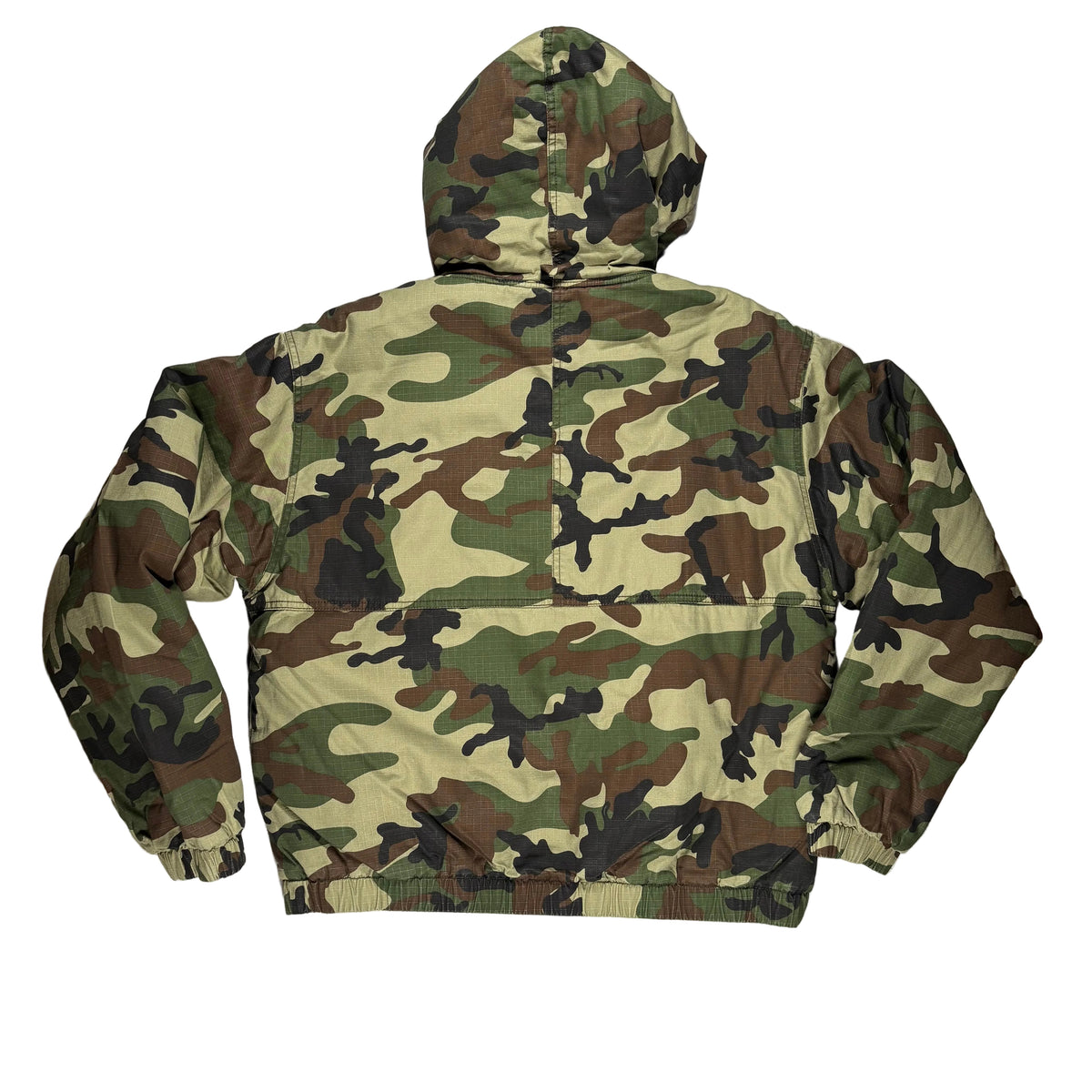Back view of a camouflage hooded jacket laid flat on a white surface.