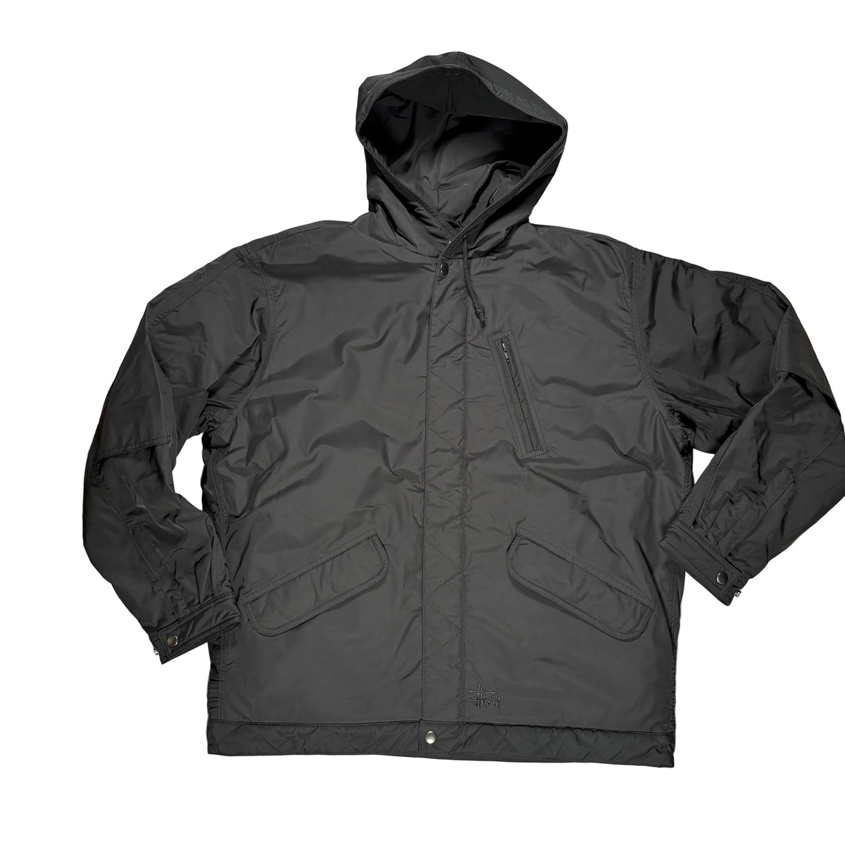 A black hooded jacket laid flat on a white surface. The jacket has a front zipper, a vertical zip chest pocket, and two large front flap pockets.