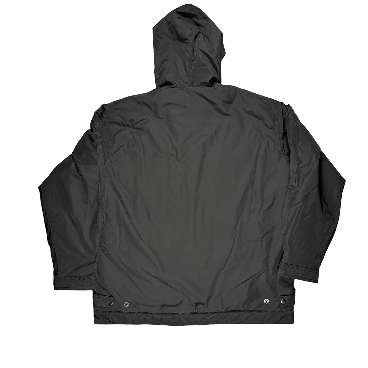 A black hooded jacket laid flat on a white surface.