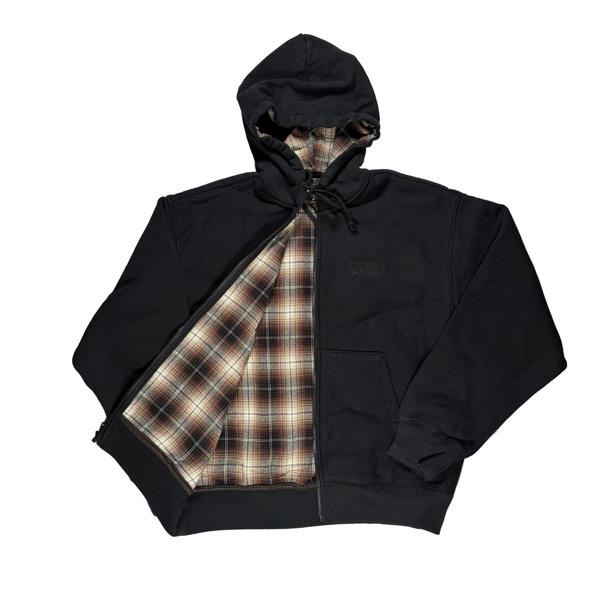 A black zip-up hoodie laid flat on a white surface, with a brown, beige, and white plaid lining visible along the zipper and hood opening. A small tonal embroidered logo is visible on the left chest.
