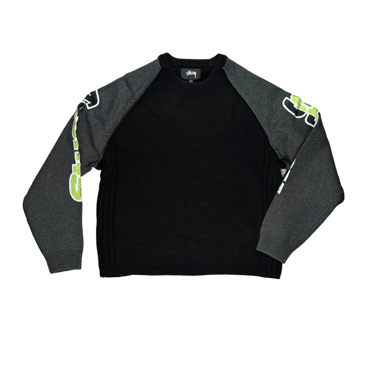 A black and gray raglan crewneck sweater with graphic prints on the sleeves, laid flat on a white surface.