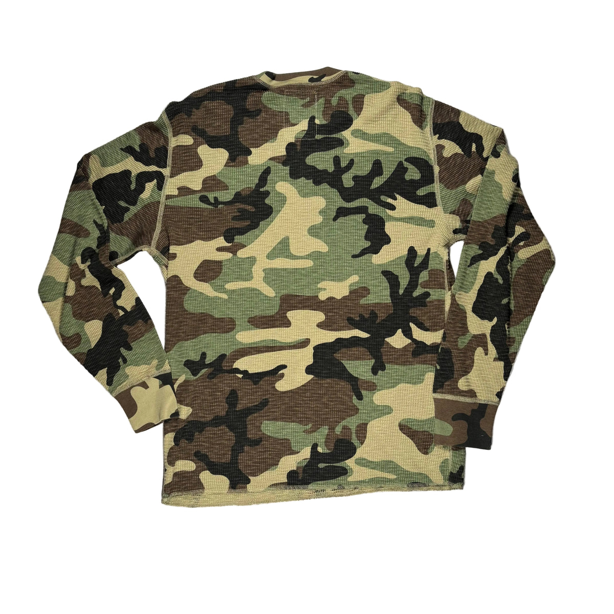 A long-sleeve crewneck shirt with a classic woodland camouflage pattern, laid flat on a white surface.
