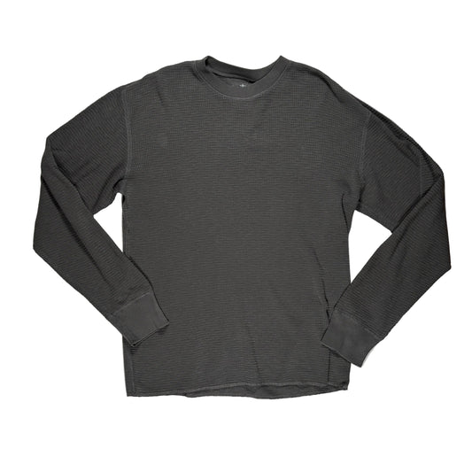 A faded black ribbed long-sleeve crewneck shirt laid flat on a white surface.