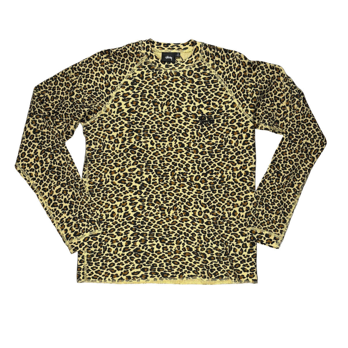 A long-sleeve crewneck shirt with a tan and black leopard print pattern, laid flat on a white surface.