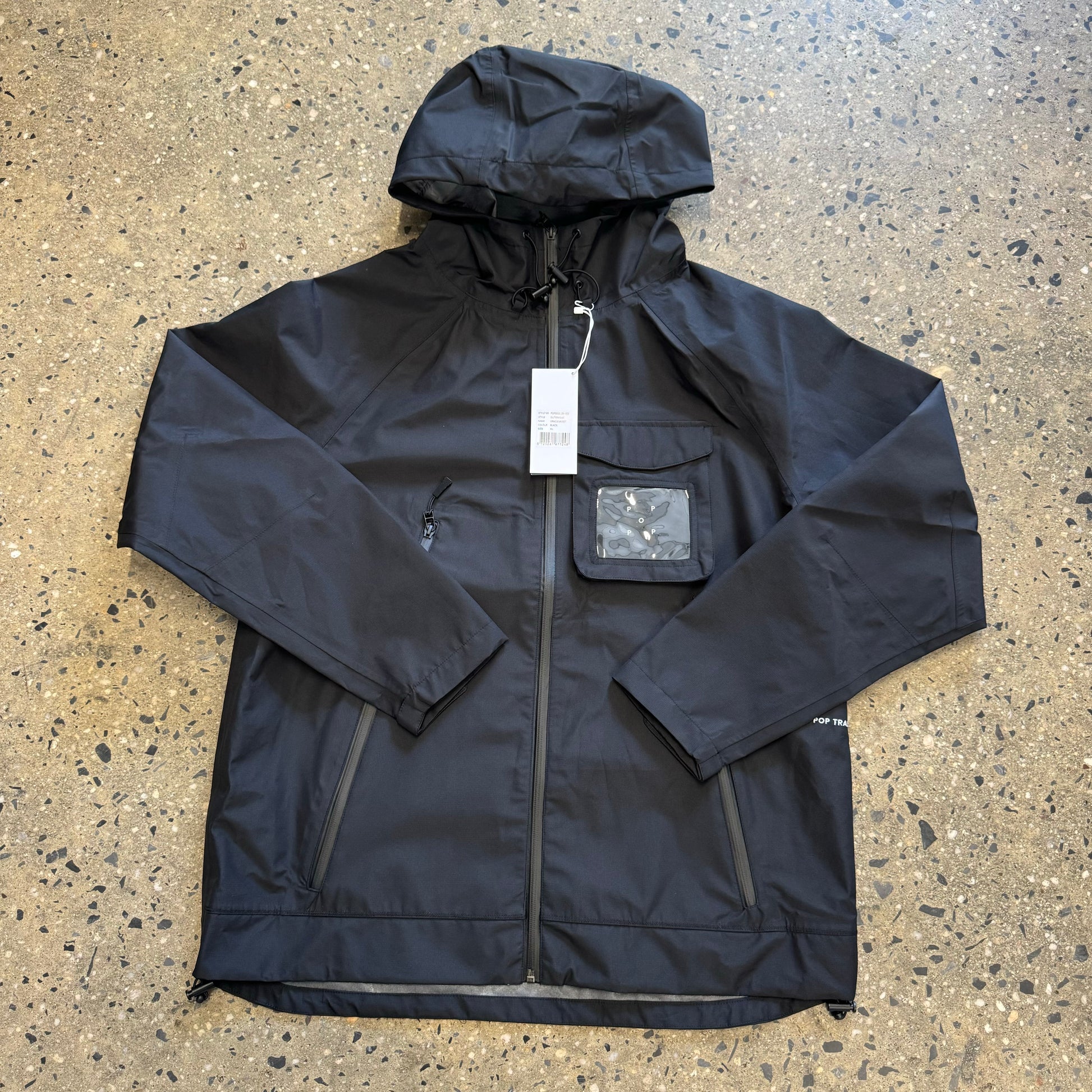 black nylon jacket with see through pocket on the left part of the chest