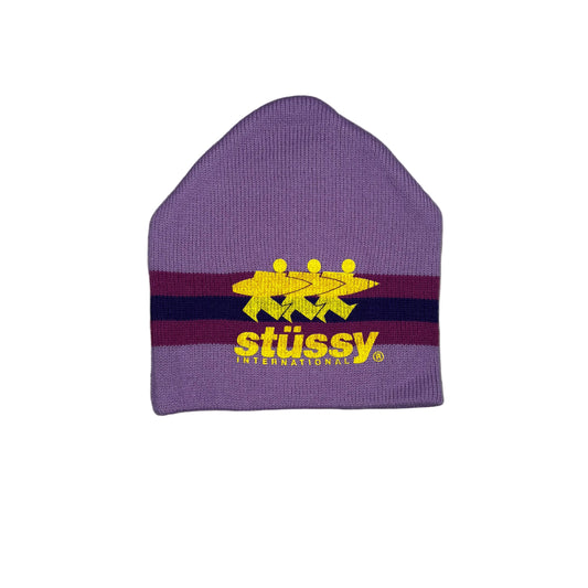 A light purple beanie with dark purple horizontal stripes and yellow Stussy logo. Displayed on a white surface.