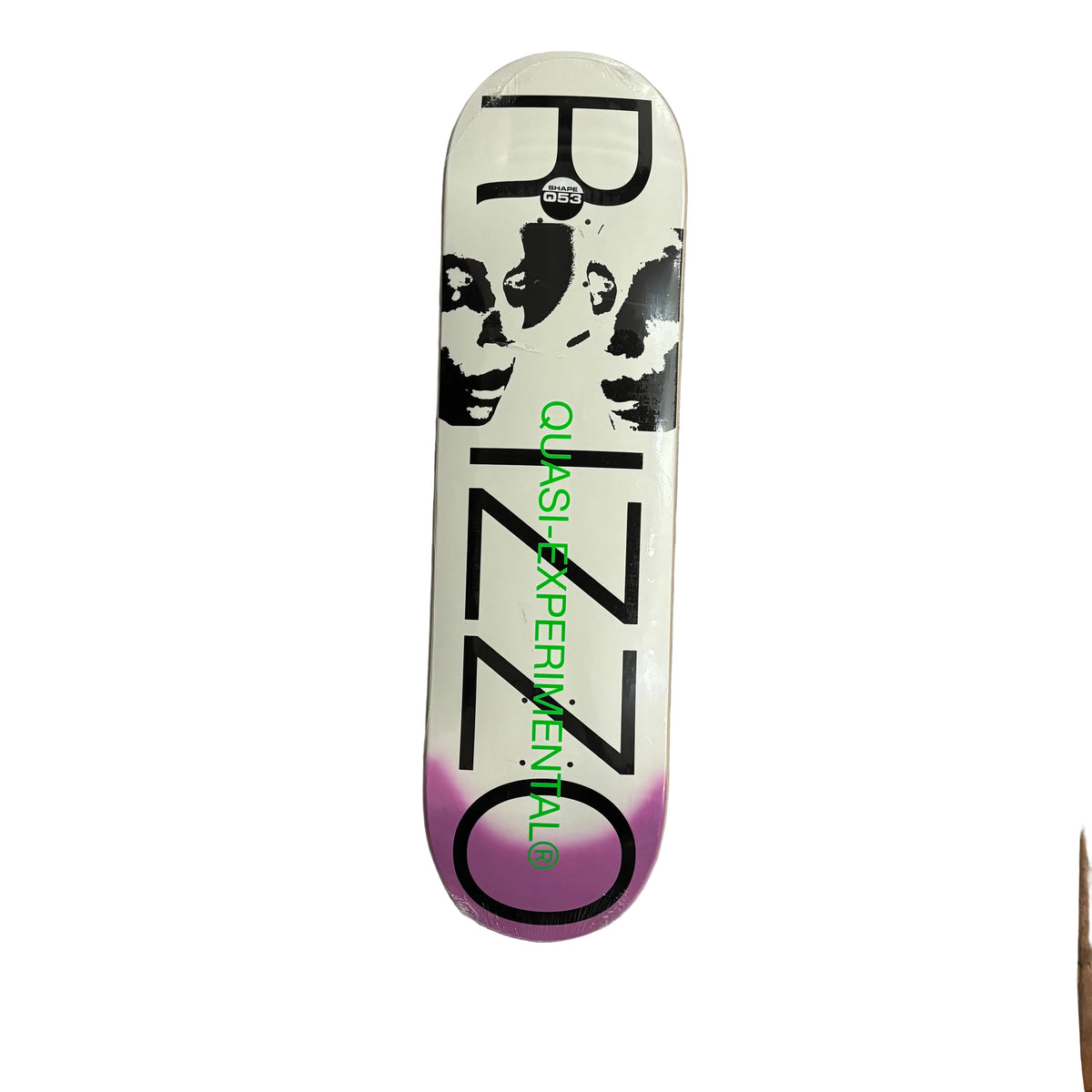 A skateboard deck featuring a white background with a black graphic of a face, large black 'RIZZO' lettering, green 'Quasi EXPERIMENTAL' text, and a purple gradient at the bottom, shown on a white surface.
