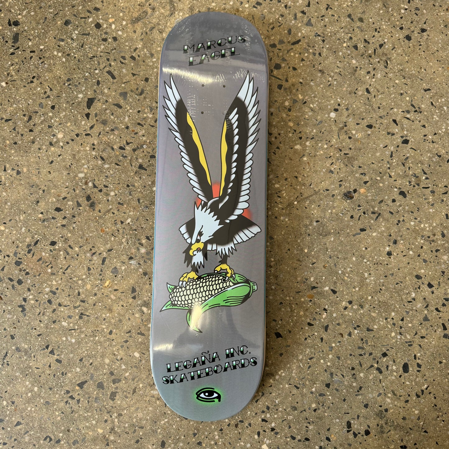 grey skateboard deck with traditional style eagle in the center