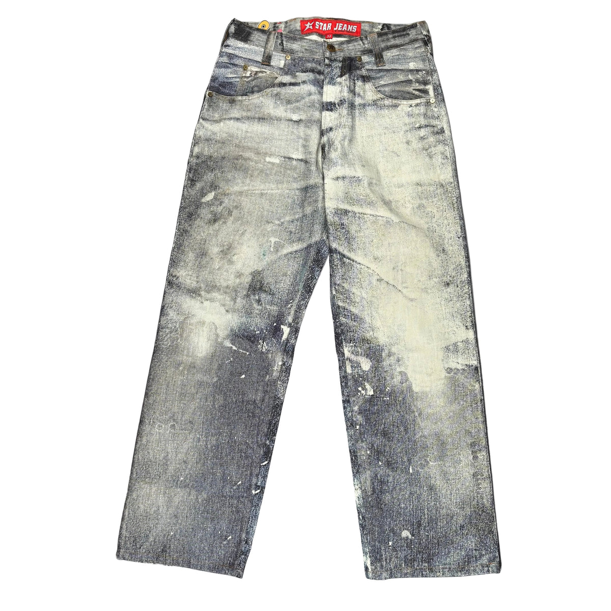 A pair of faded gray denim jeans laid flat on a white surface. The jeans have a heavily washed, distressed look.