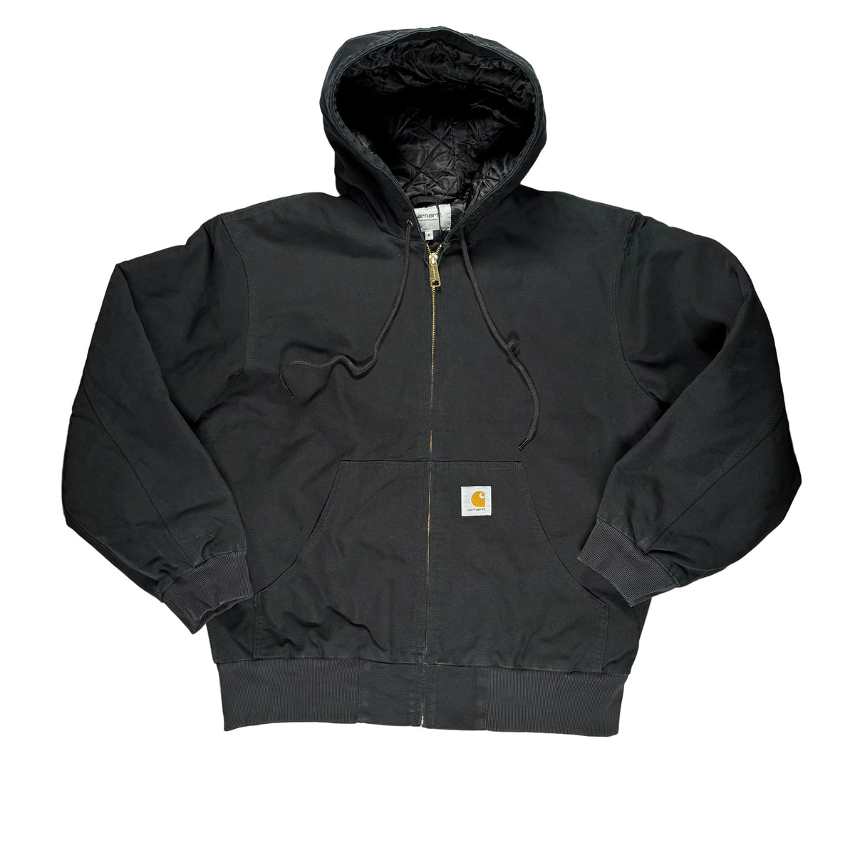 A black Carhartt zip-up hooded jacket laid flat on a white surface. 