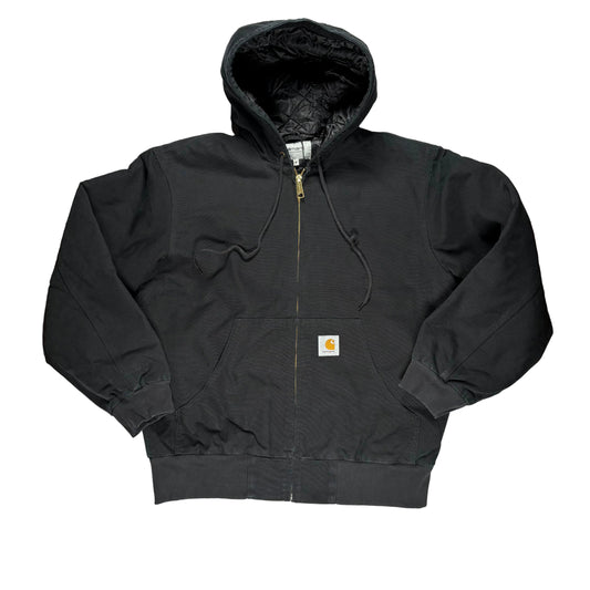 A black Carhartt zip-up hooded jacket laid flat on a white surface. 