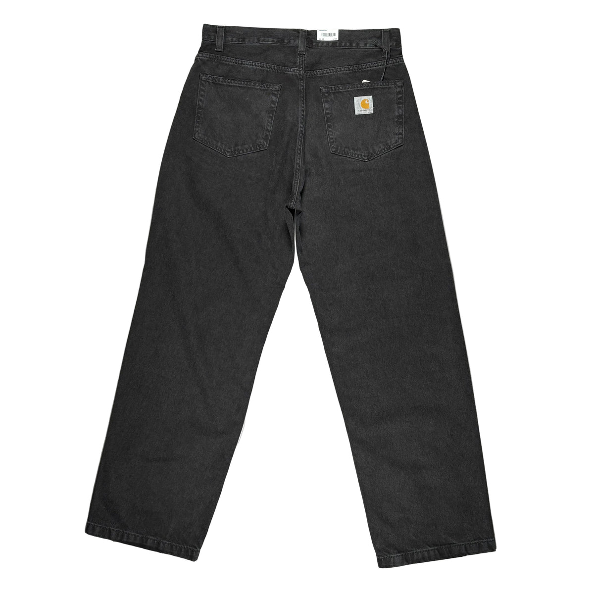 Black Carhartt denim jeans shown from the back, laid flat on a white surface. The Carhartt brand patch is visible on the back right pocket.