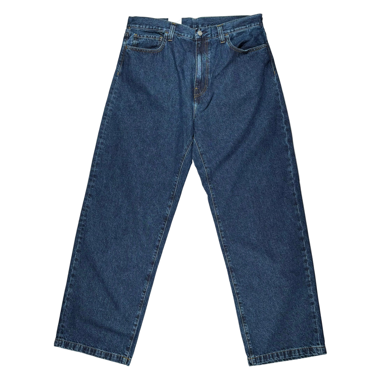 A pair of dark blue denim jeans laid flat on a white surface. 