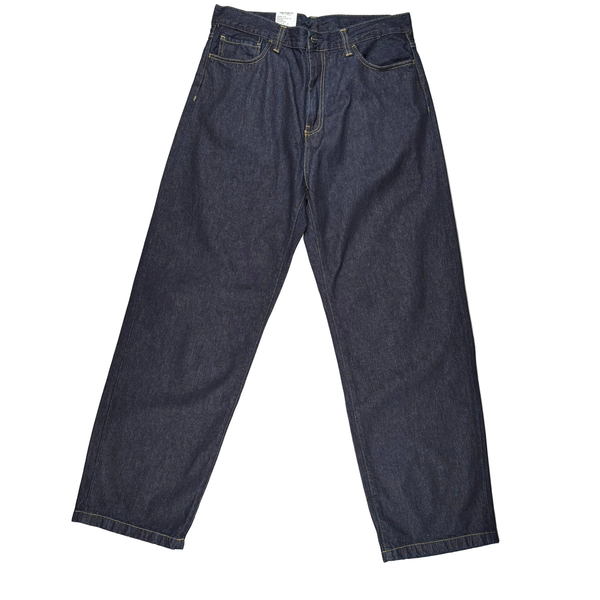 A pair of dark indigo denim jeans laid flat on a white surface
