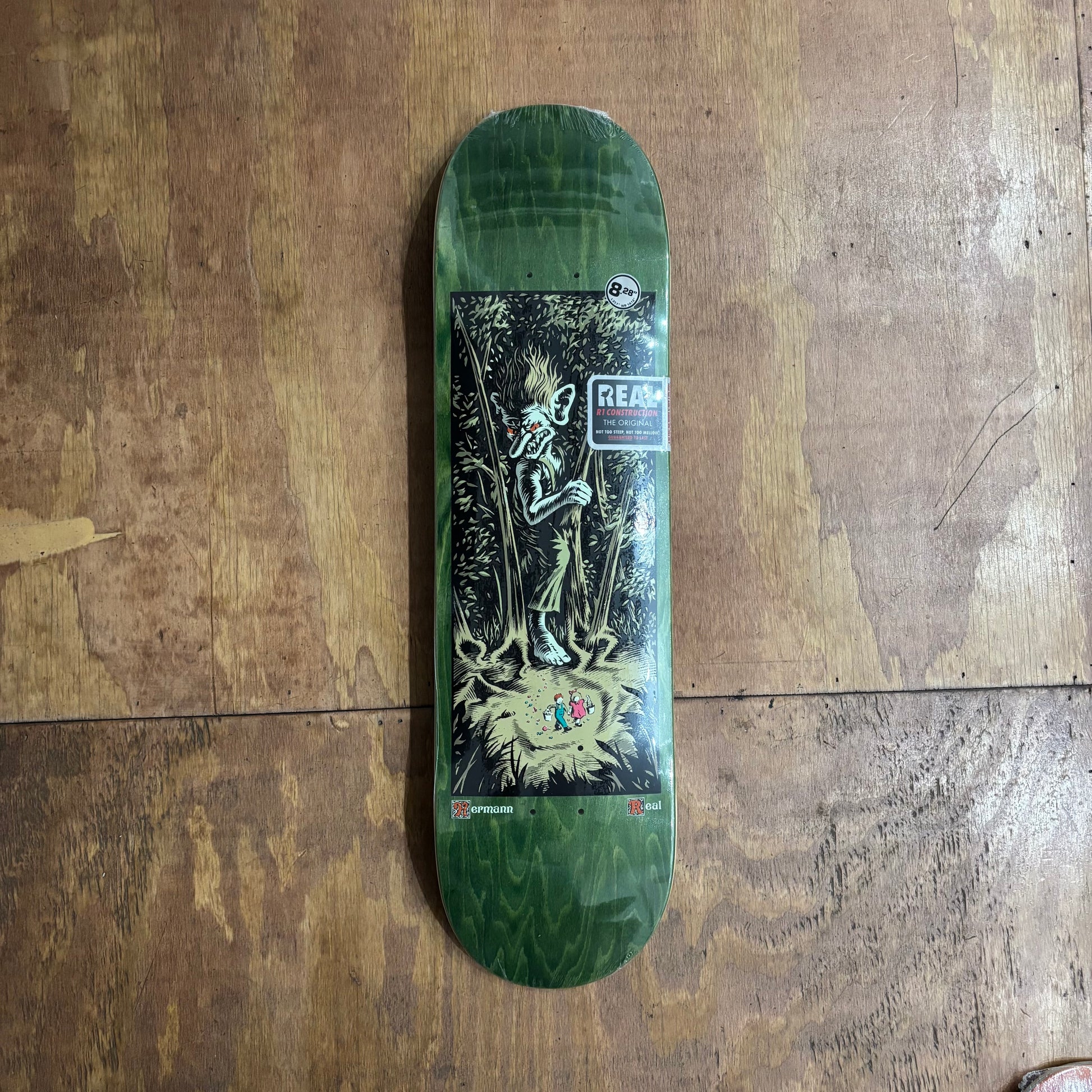 troll in the woods graphic on woodgrain skateboard deck