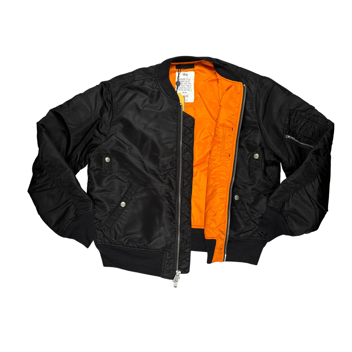 A black nylon bomber jacket with a bright orange quilted lining, laid flat on a white surface.