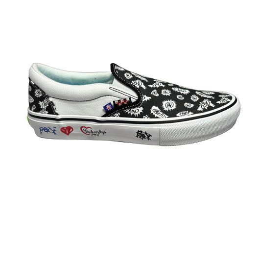 Side view of a black and white slip on sneaker with a white sole, displayed on a white surface.