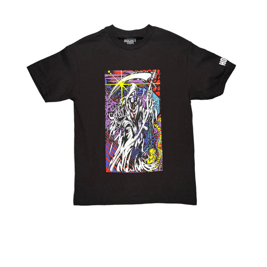 A black short-sleeve graphic t-shirt laid flat on a white surface. The shirt features a large, colorful graphic print on the front depicting a grim reaper with a scythe, and white text on the right sleeve.