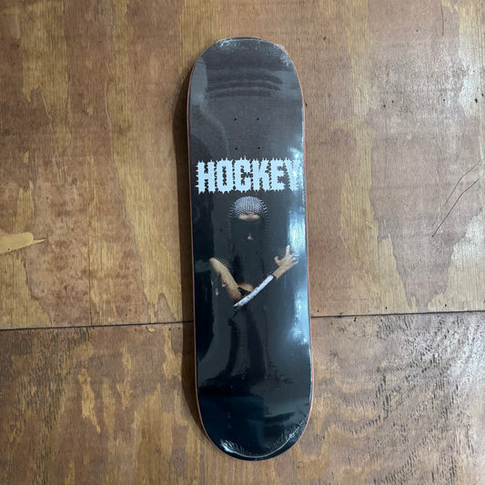 metal looking human showing off arms on black deck that reads HOCKEY