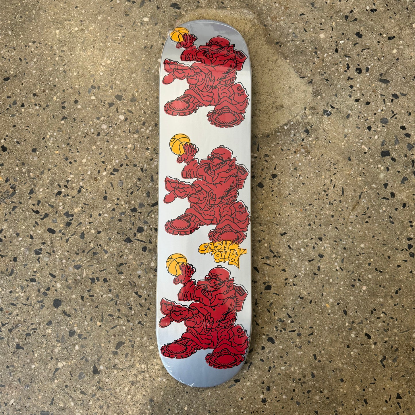 silver skateboard deck with red characters holding a basket ball