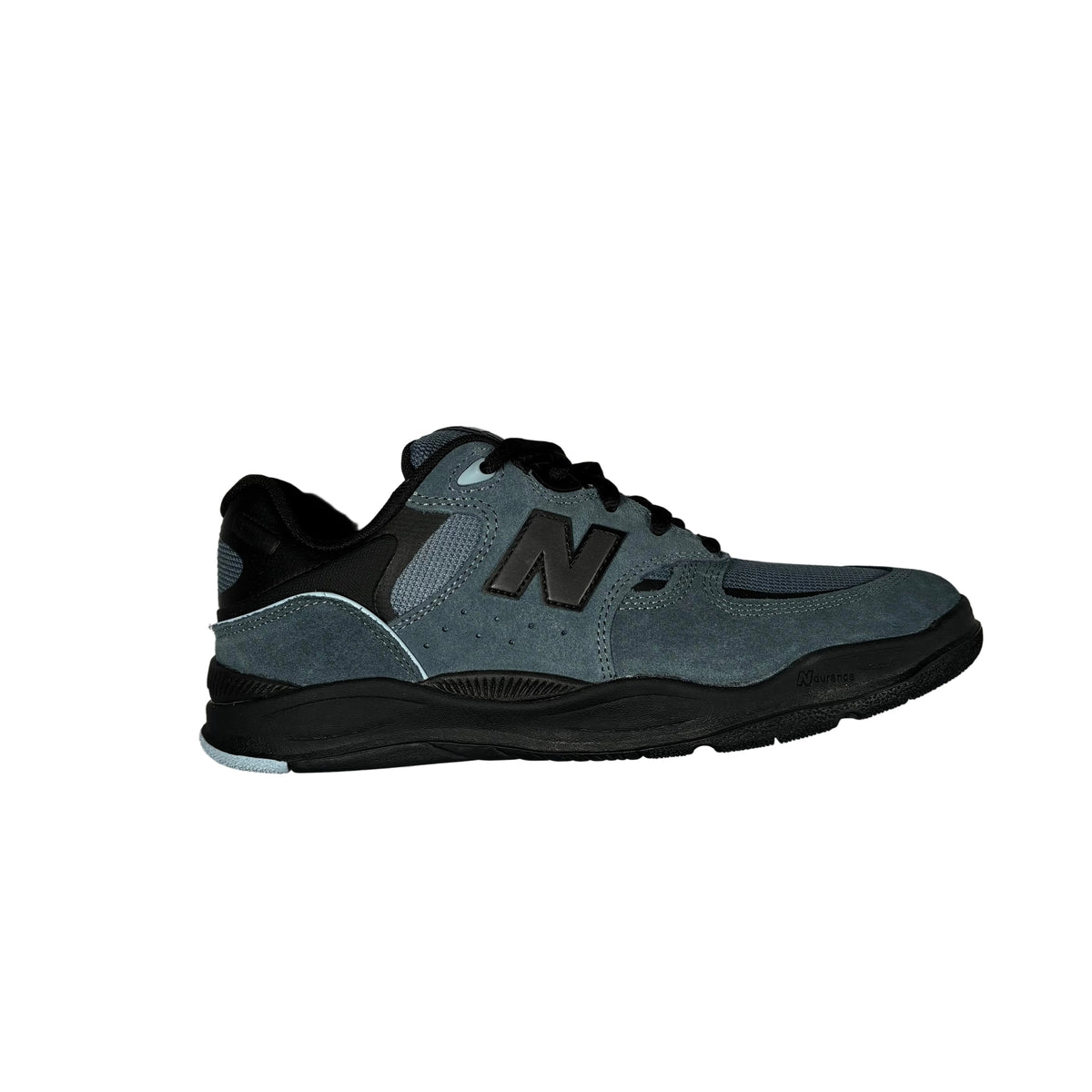 A single New Balance sneaker in slate blue and black, shown from a side profile view on a white background.