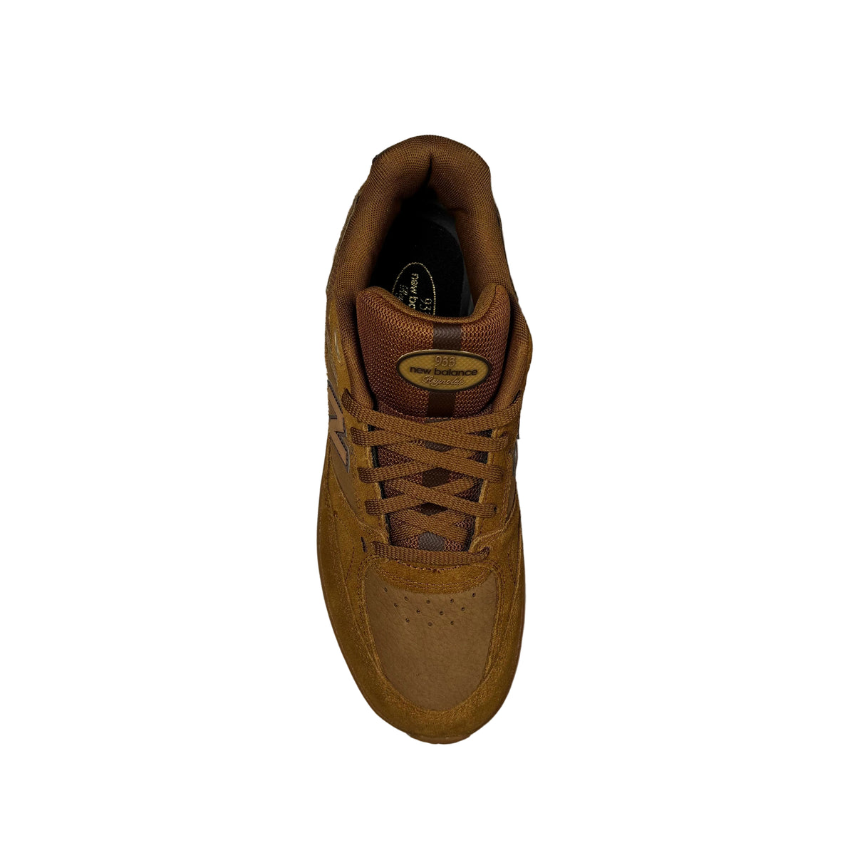 A single brown suede and mesh sneaker shown from a top-down view on a white surface. The shoe features a brown lace, a brown tongue with a gold oval logo, and a dark brown inner lining.