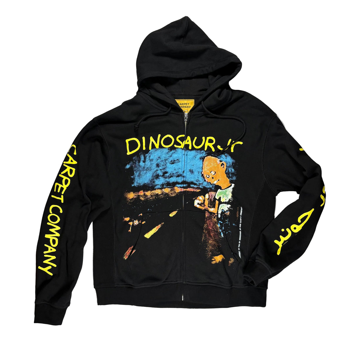 A black zip-up hoodie laid flat on a white surface. The hoodie has a large multicolor graphic on the front with yellow text reading 'DINOSAUR JR' and yellow vertical text on both sleeves reading 'CARPET COMPANY.