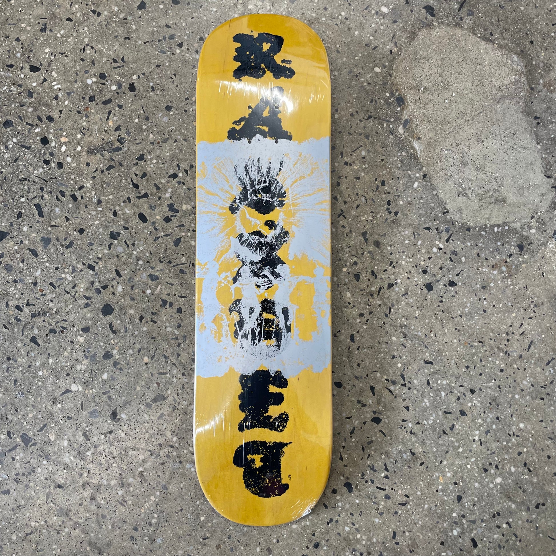 yellow, black, white abstract design on skate deck