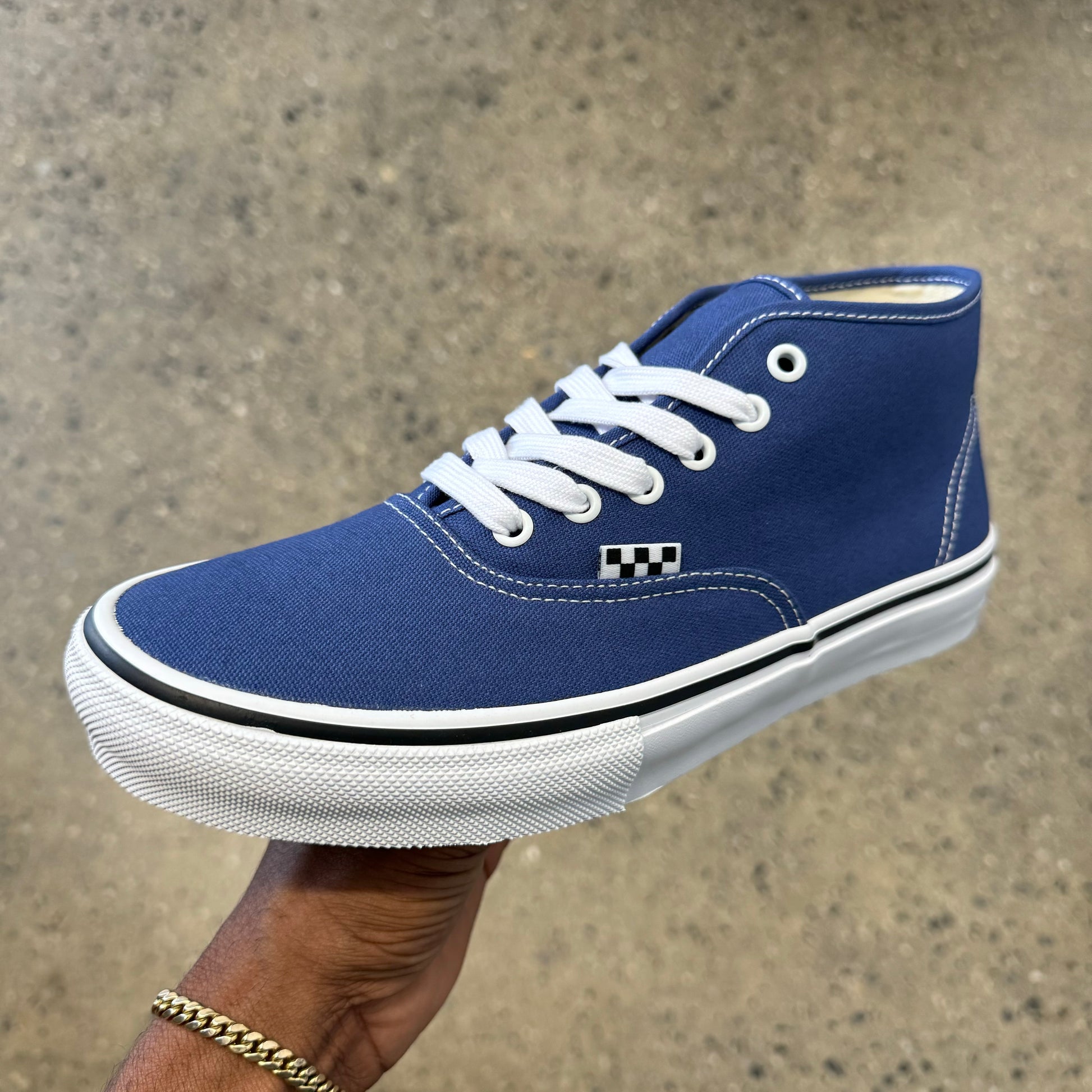 navy blue canvas shoe with white stitching