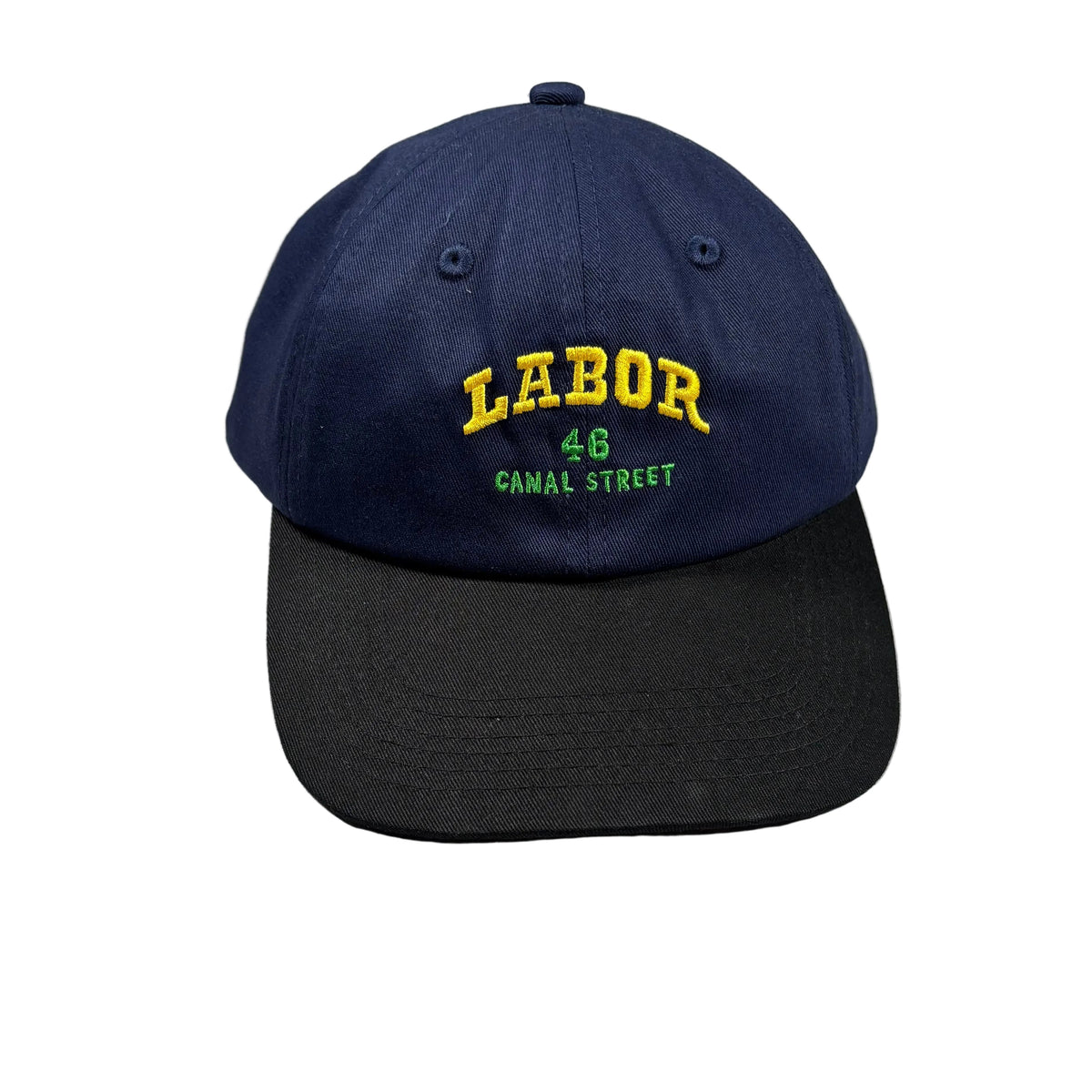 A navy blue baseball cap with a black visor, featuring yellow and green embroidered text reading 'LABOR 46 CANAL STREET' on the front, displayed on a white surface.