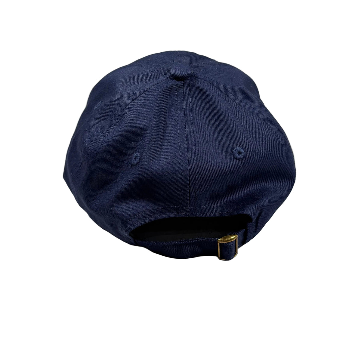 A navy blue baseball cap viewed from the back, resting on a white surface