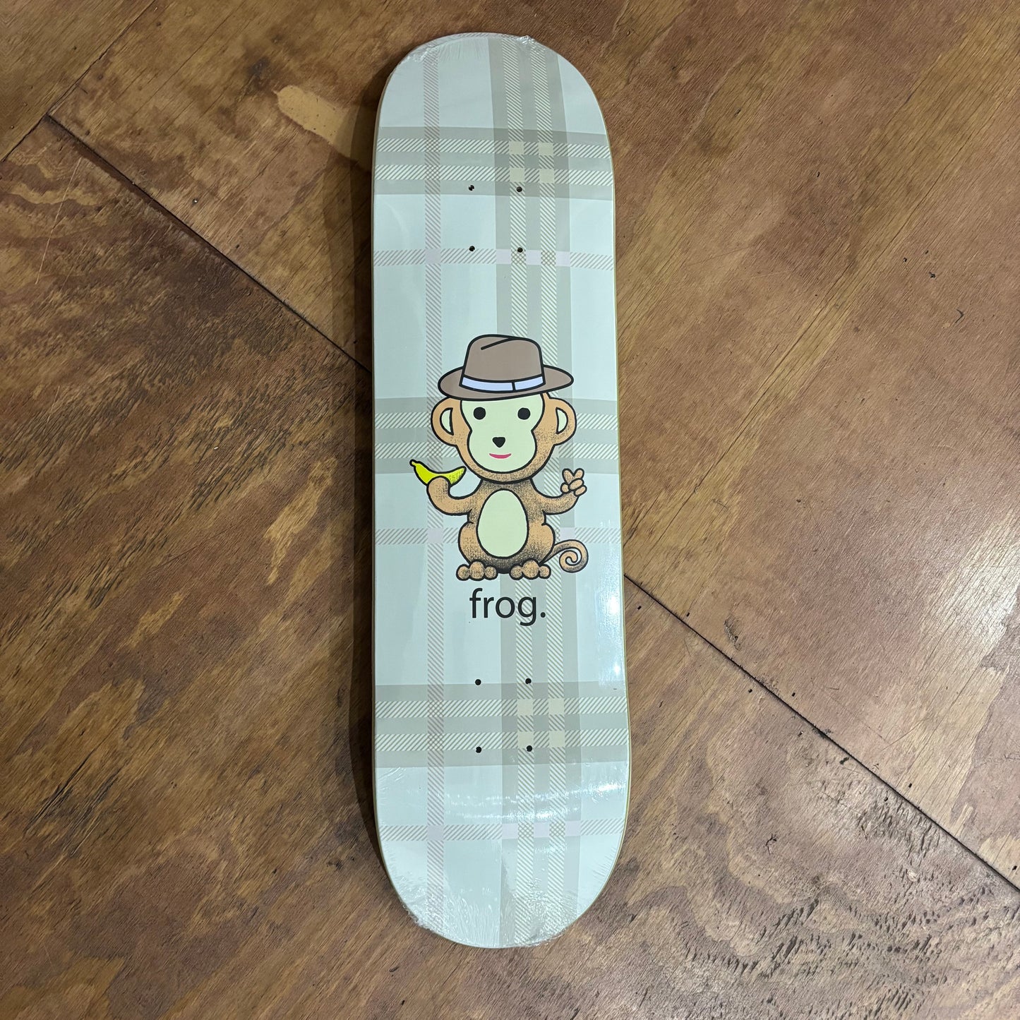plaid skateboard deck with cartoon monkey