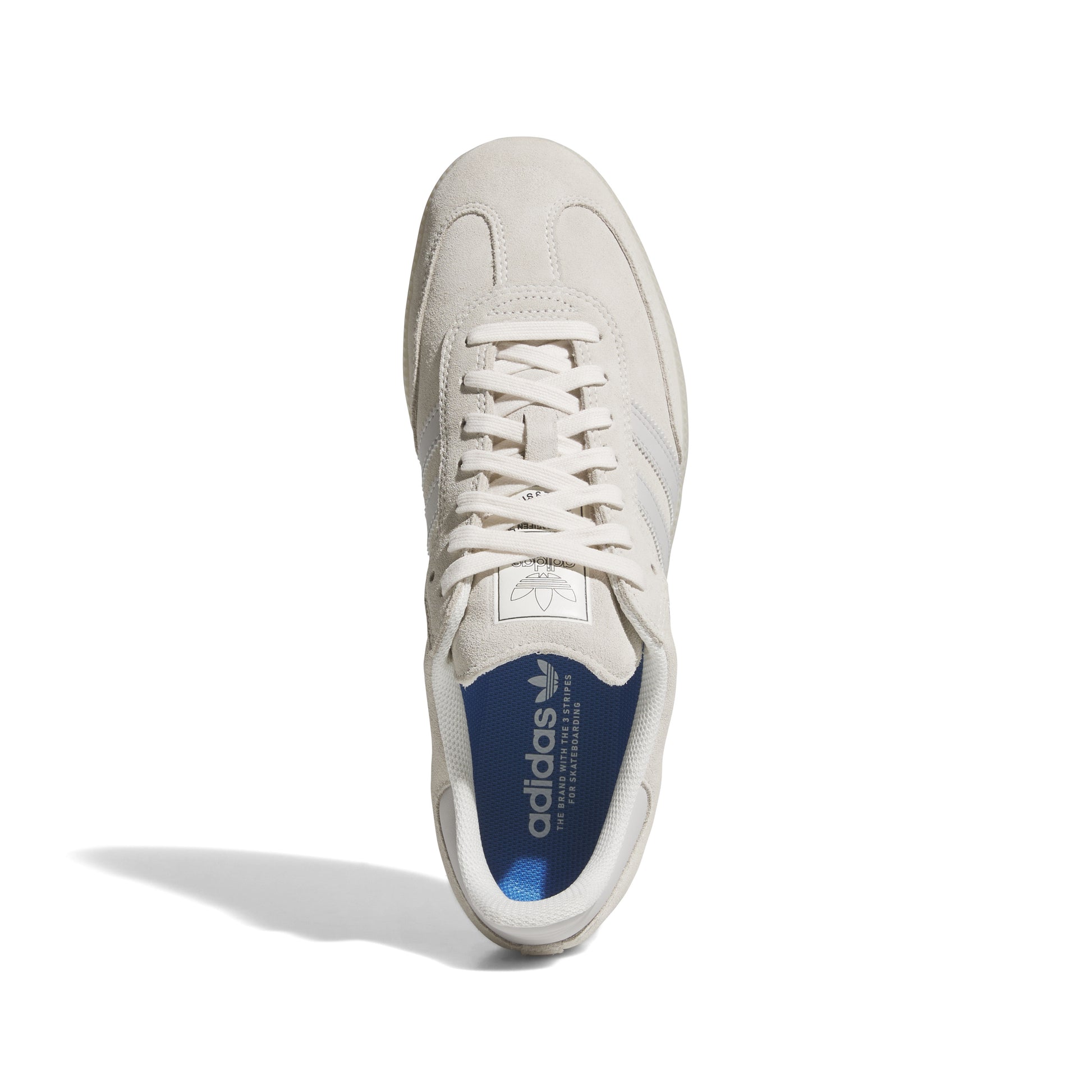 Top down view of white suede lowtop skateboard sneaker with clear gum rubber sole
