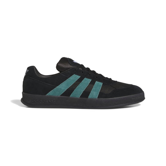 Black Adidas sneaker with teal stripes on a white background