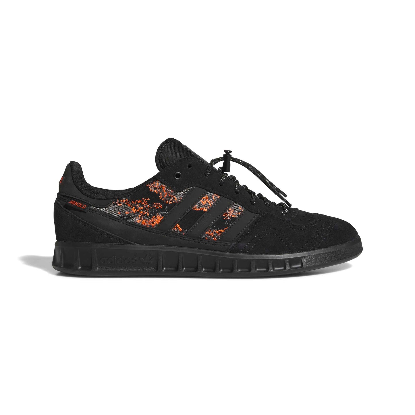 Black Adidas sneaker with orange accents on a white background
