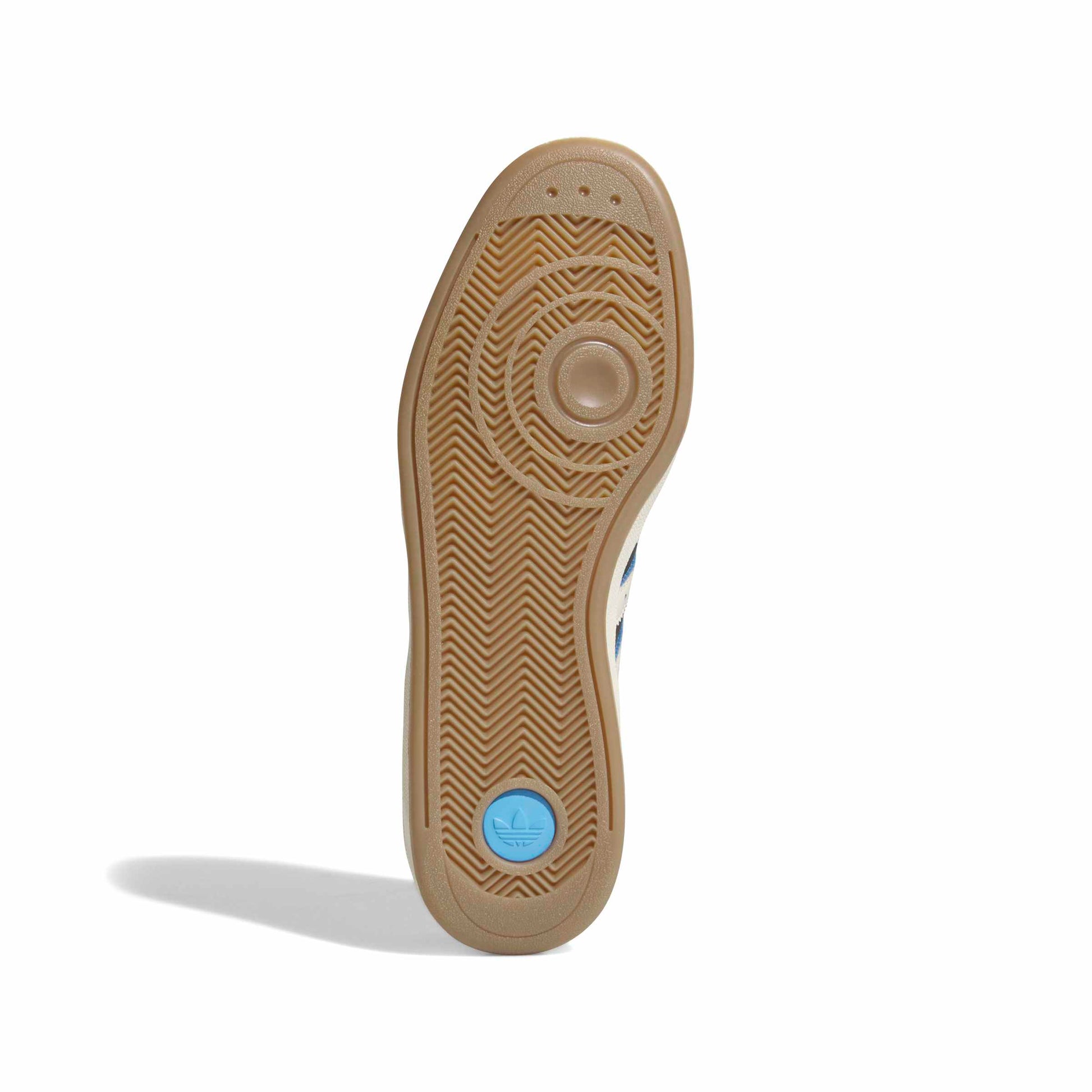 Close-up of a shoe sole with a blue circular label on a white background