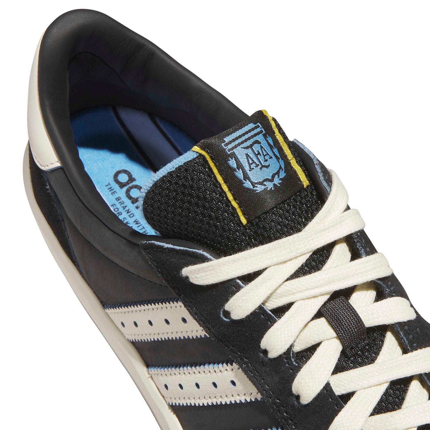 Black and white sneaker with a brand logo on a white background
