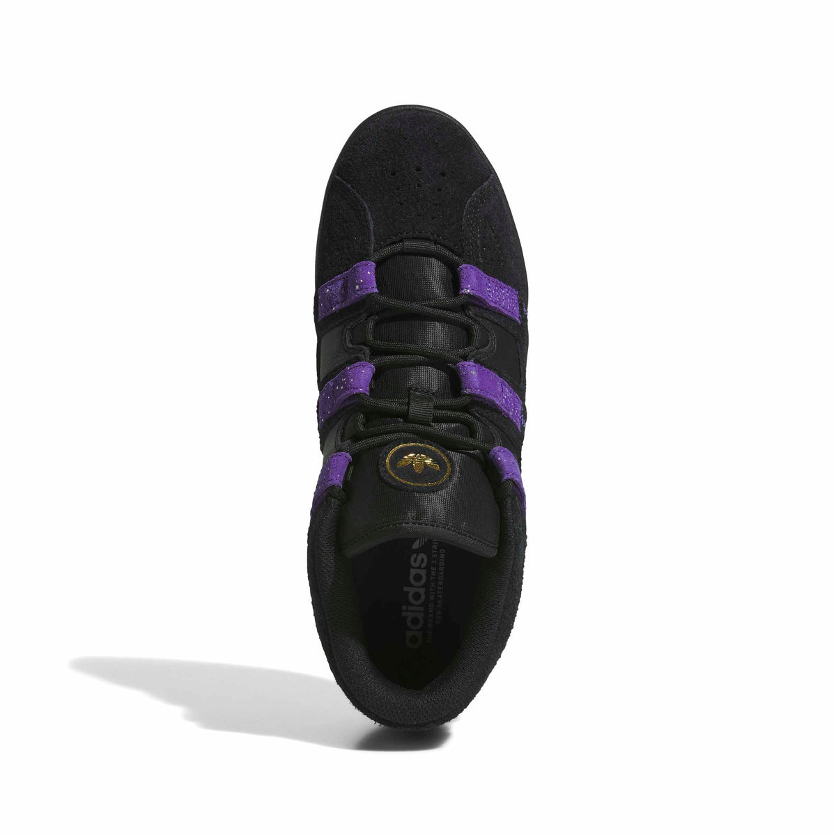 A single Adidas sneaker shown from a top-down view on a white background. The shoe is primarily black with prominent purple stripes and a small gold logo on the tongue.