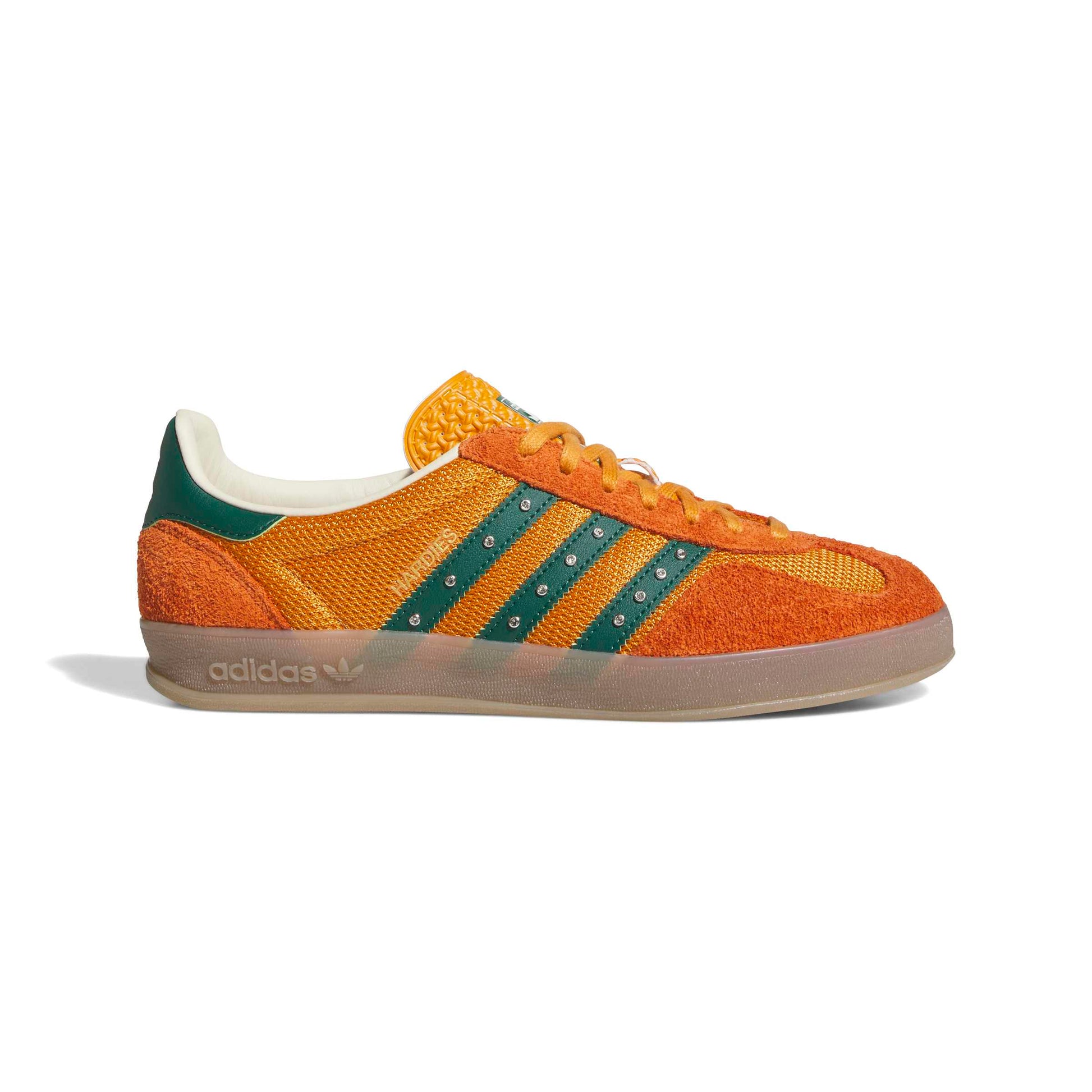 Orange Adidas sneaker with green stripes on a white background