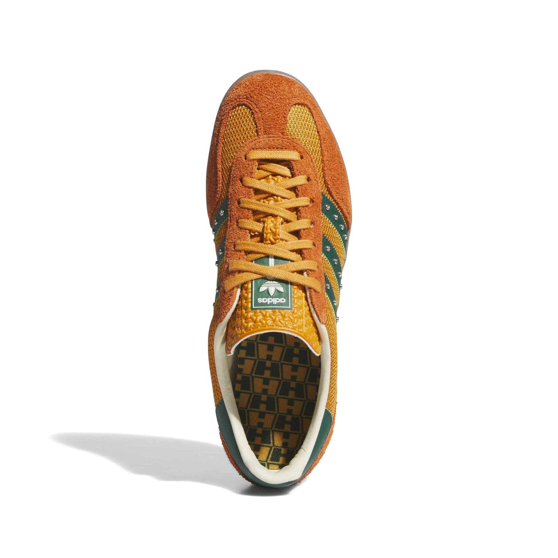 Orange sneaker with green accents on a white background