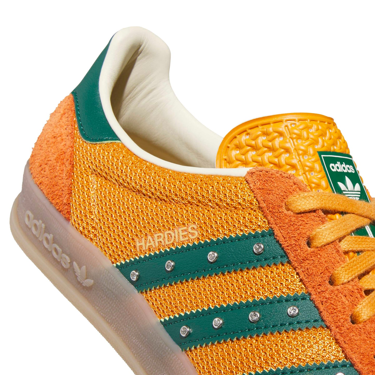 Adidas sneaker with orange and green design on a white background