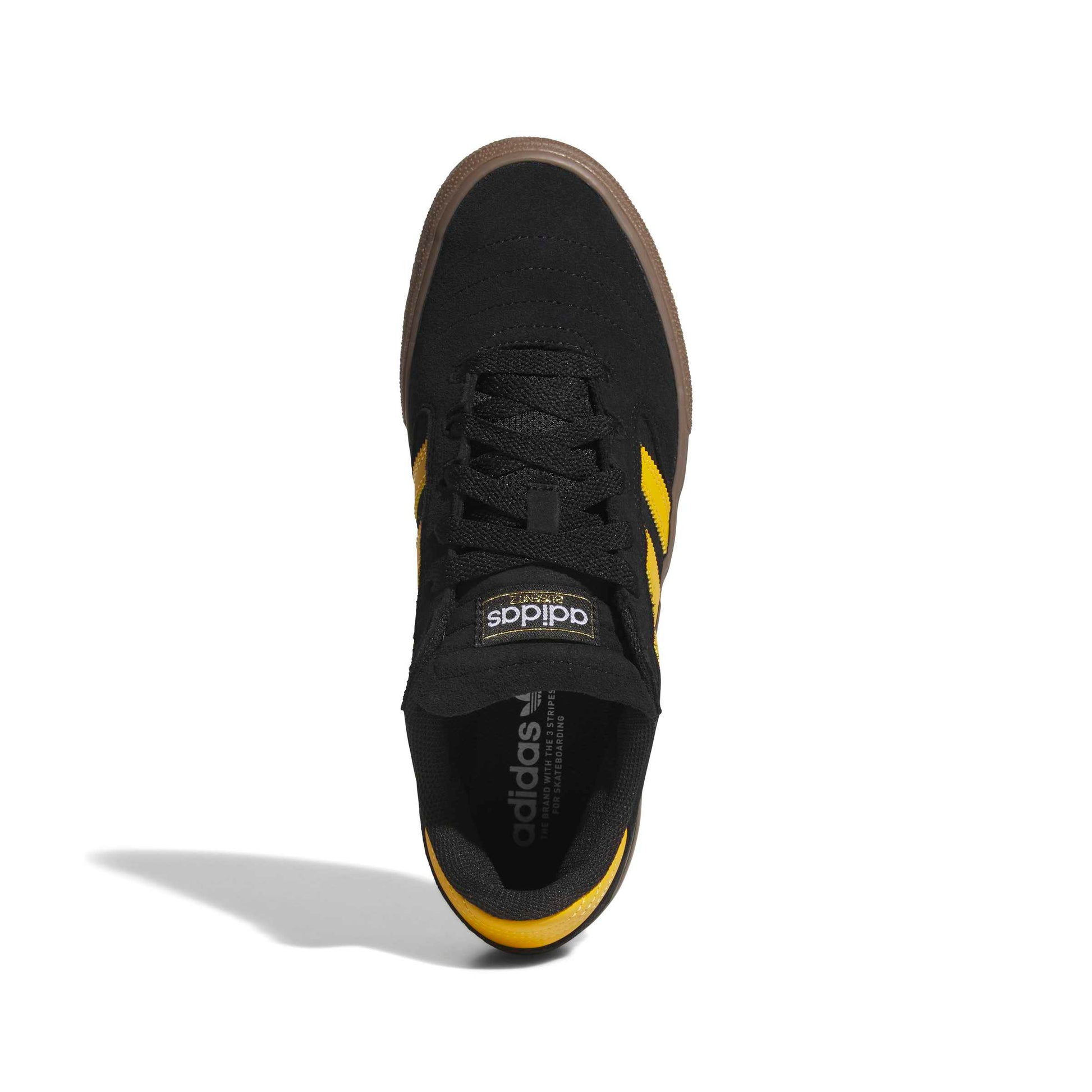 A single Adidas sneaker shown from a top-down view on a white background. The shoe features a black upper, black laces, a thick brown platform sole, and yellow stripes on the sides.