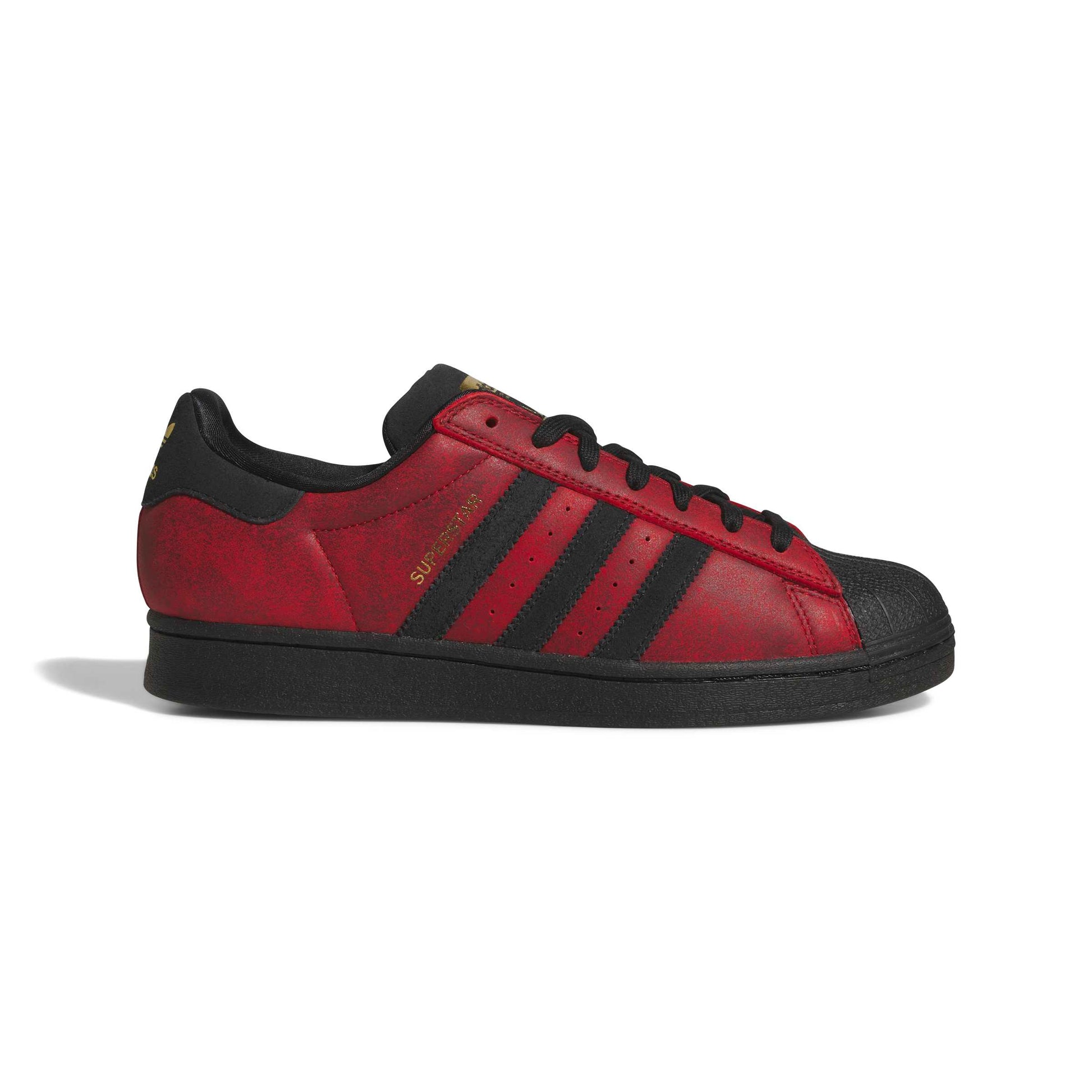 A red and black Adidas Superstar sneaker shown from the side profile on a clean white background.