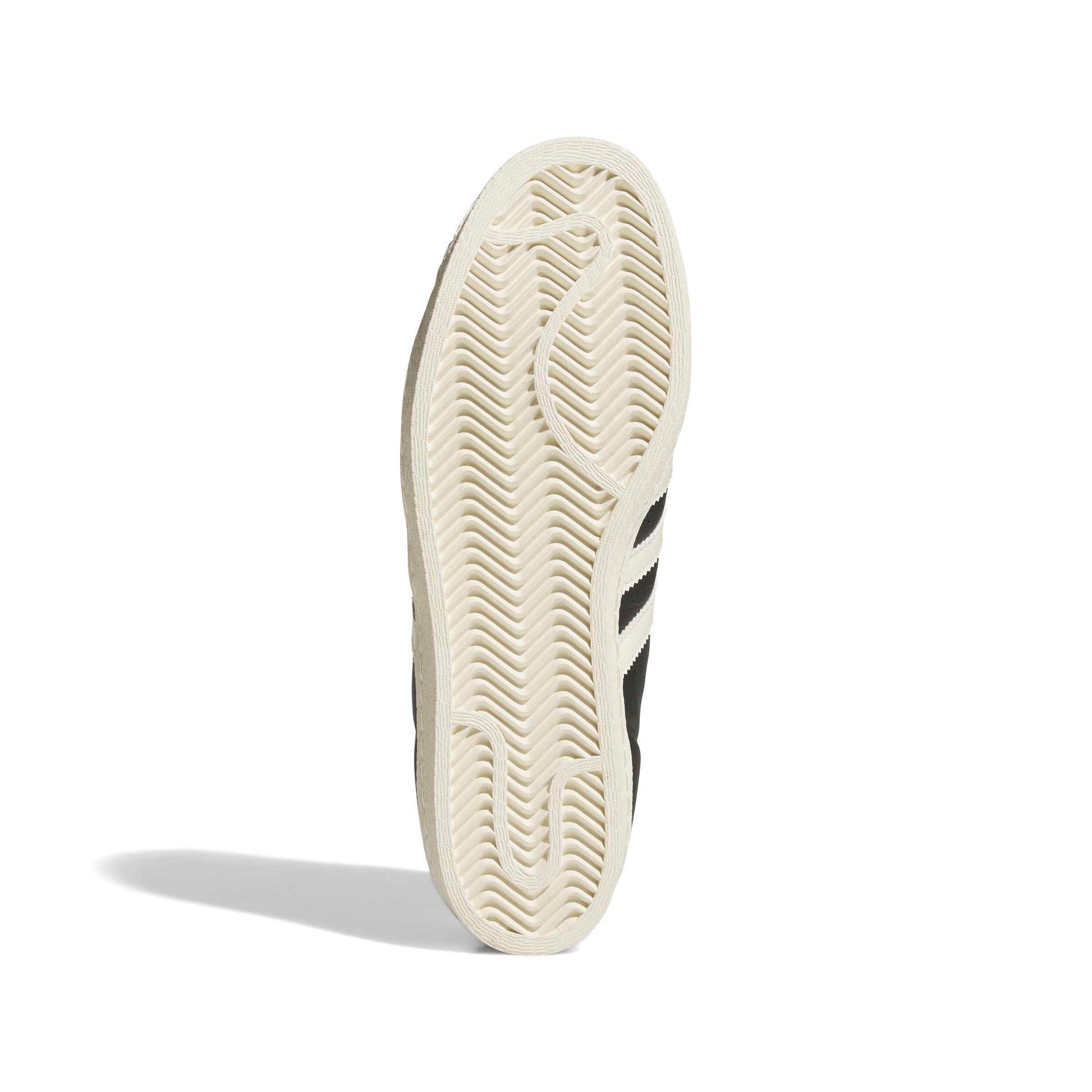 Close-up of a sneaker sole with brand logo on a white background