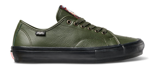 An olive green Vans platform sneaker with a textured leather upper, matching green laces, a black rubber sole, and a small red Vans logo on the tongue and heel.