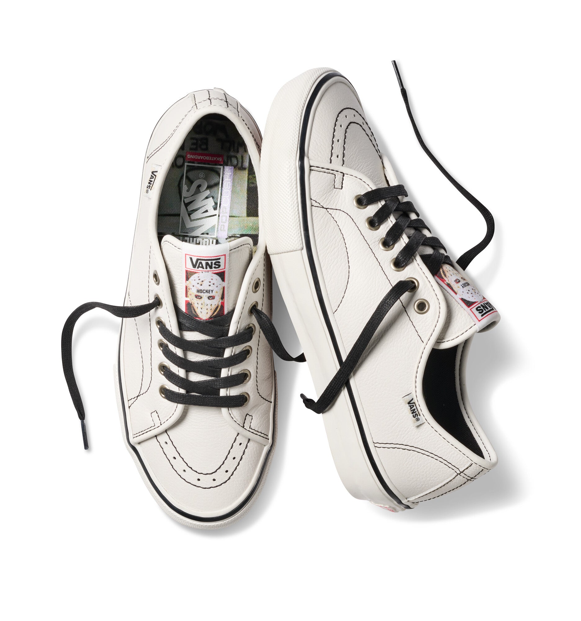 White sneakers with black laces on a white background