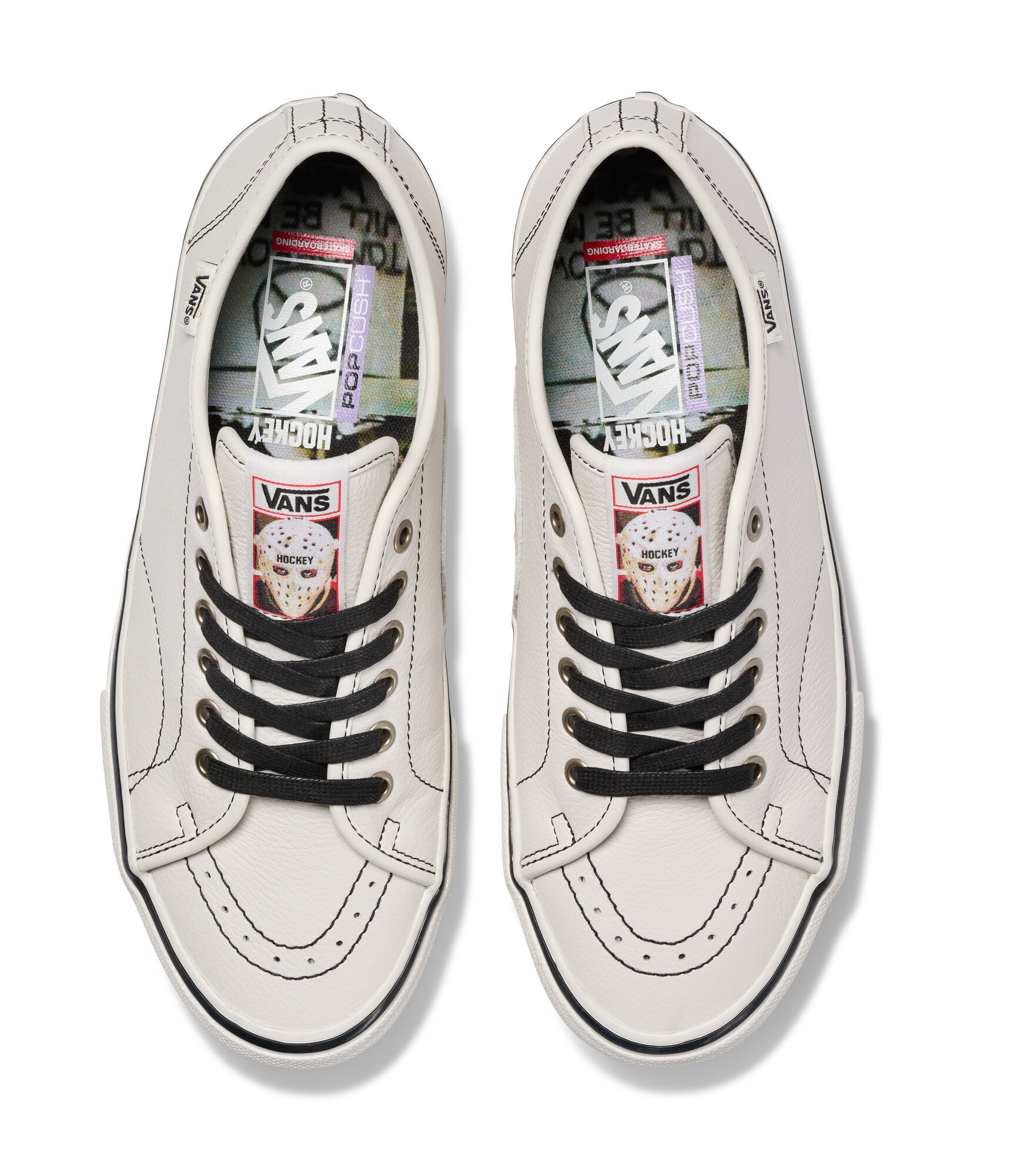 Pair of white Vans sneakers with black laces on a white background