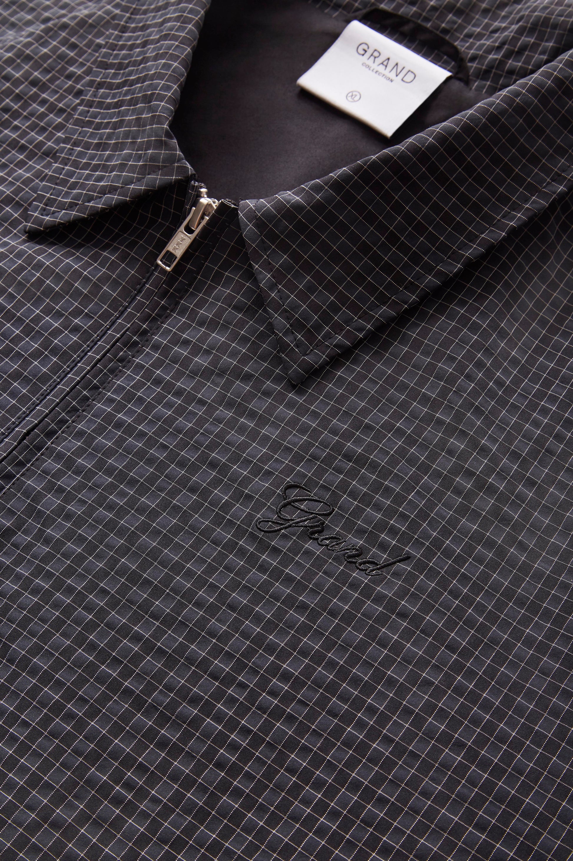 collar and zip detail on mini check poly jacket