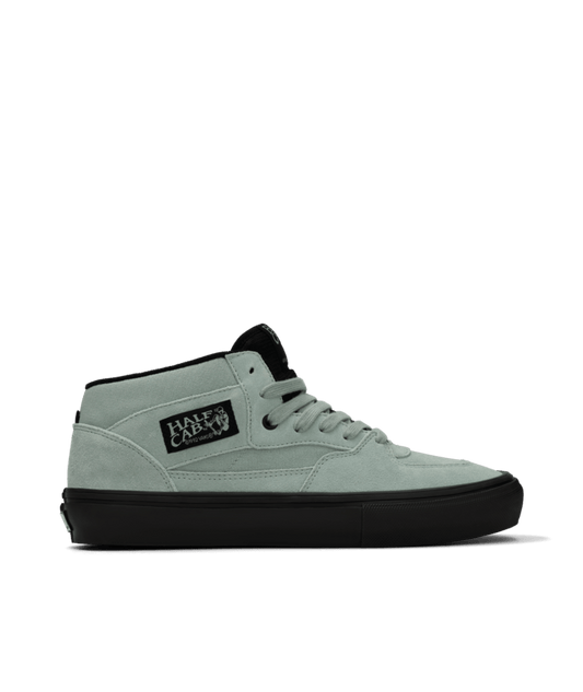 White high-top sneaker with black sole on a white background